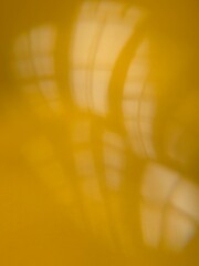 abstract orange yellow variegated background with window shadows