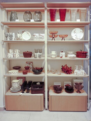 Shelf with plates, vases, glasses in the sales area of ​​the store