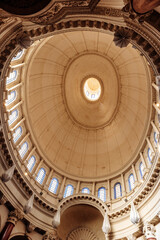Obraz premium Ornate dome of Basilica of Our Lady of Mount Carmel with limestone arches and blue windows, iconic landmark in central Valletta