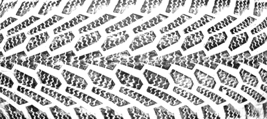 black traces of tractor tires on white background.