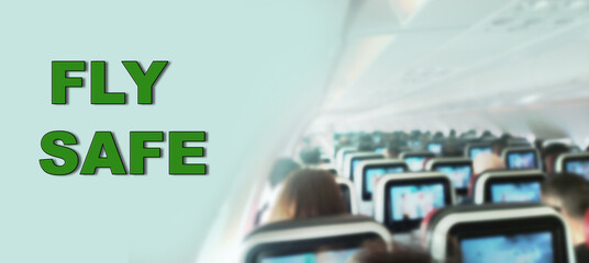 Fly safe text on the passenger cabin photo. Safety precaution during the flight