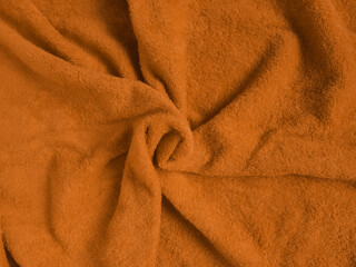 Terry cloth folded folds from the center mustard color. Background, texture.