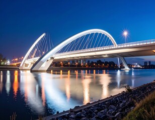 Naklejka premium Evening view of a modern bridge over water with reflections and city lights in the background