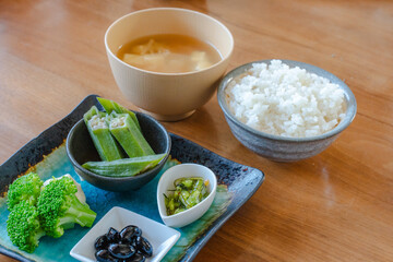 Japanese breakfast with rice miso soup and vegetable side dishes
