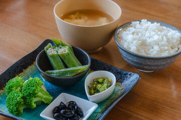 Japanese breakfast with rice miso soup and vegetable side dishes
