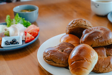 Breakfast with bread rolls and Japanese Western style side dishes
