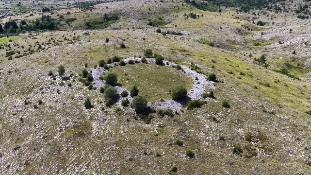 Drone top view of circular Illyrian gradina built from stacked dry stone walls