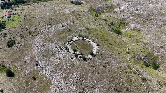 Aerial footage of prehistoric Illyrian fortification remains surrounded by Glasinac forest and meadows