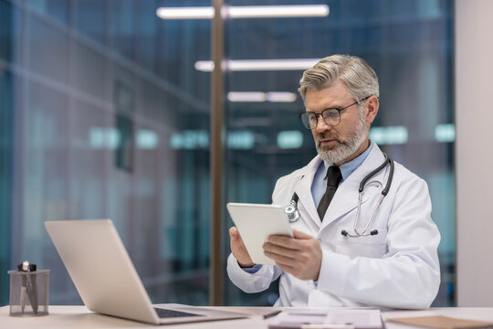 Doctor using a digital tablet in a modern office environment