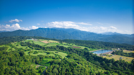 View of Toyama Bay, the Kurobe River alluvial fan, the Hokuriku Shinkansen, and farms from Kurobe City in eastern Toyama Prefecture, Japan