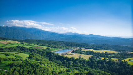Fototapeta premium View of Toyama Bay, the Kurobe River alluvial fan, the Hokuriku Shinkansen, and farms from Kurobe City in eastern Toyama Prefecture, Japan