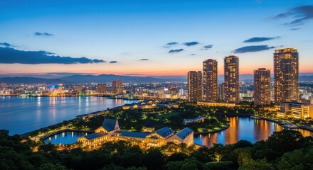 Fototapeta premium Dramatic panorama of a cityscape and lakeside buildings during twilight glow