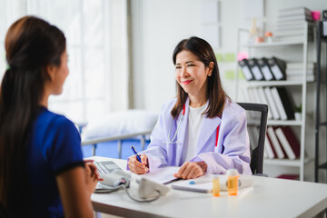 Fototapeta premium Doctor taking notes while listening to patient explaining her symptoms