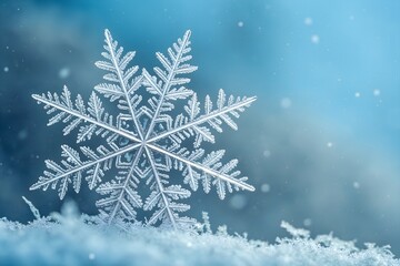 Stunning close up of a real snowflake resting on snow crystals against a dreamy blue background
