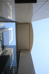 Modern skyscrapers with glass and metal facades, upward perspective
