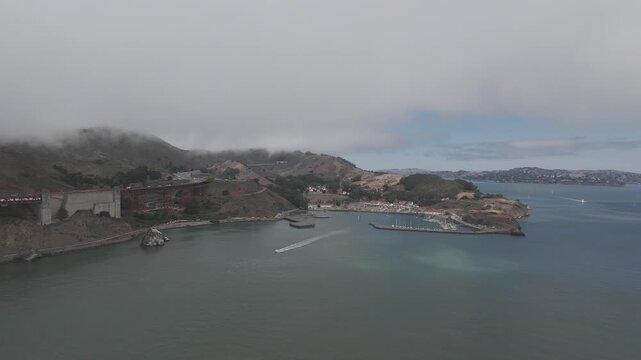 RAW Aerial of Fort Baker and Horseshoe Cove Marina beneath Marine Layer, Golden Gate National Recreation Area, San Francisco Bay &mdash; Advection Fog, Headlands, Harbor and Coastal Microclimate