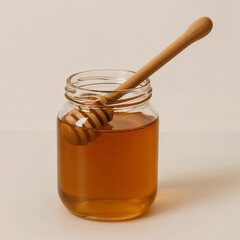 A jar of golden honey with a wooden dipper, ready to be enjoyed.