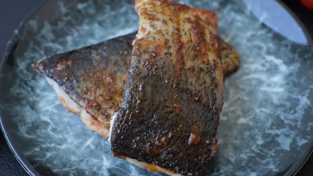 Food, seafood, grilled fish fillet with lemon, salt and spices. Grilled fish fillet for lunch, healthy food