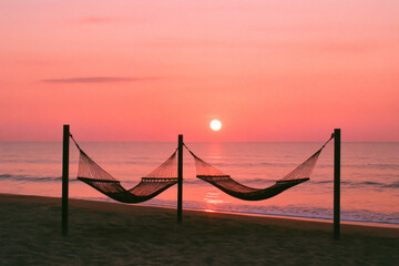 Romantic seascape sunset with calm ocean waves, glowing horizon, orange sky, and peaceful tropical summer evening.