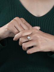 A woman's elegant finger ring with a white diamond