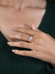 A woman's elegant finger ring with a white diamond