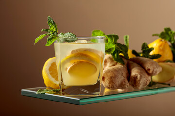 Ginger cocktail with lemon and mint in a frozen glass.