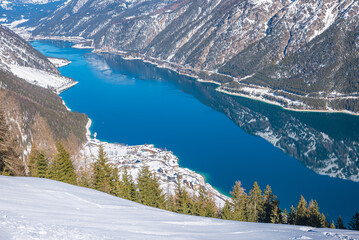 view from Zwolferkopf mountain down to pertisau tourist resort and lake Achensee in winter