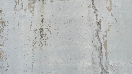 old peeling white wall texture with cracked paint and weathered surface