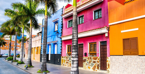 Tenerife. Colourful houses and palm trees on street in Puerto de la Cruz town, Tenerife, Canary Islands, Spain