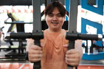 Overweight Man Doing Lat Pulldown Exercise at Gym. Upper Body Strength Training