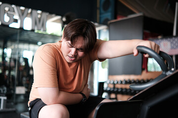 Fitness burnout. A plus-size man resting on a mat after reaching his limit.