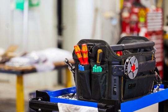Toolbox resting on top of blue cart inside workshop