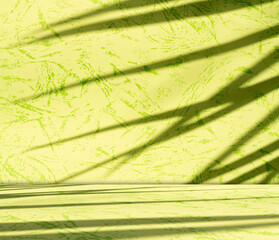Yellow background wall gradient orange color studio room solid podium with shadow leaf on floor,...