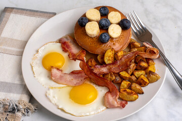 fried eggs with pancakes and homefries