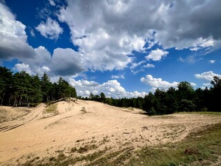 Beautiful day in Latvia, white fluffy clouds and blue sky. 