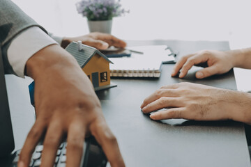 Real estate broker agent presenting and consult to customer to decision making sign insurance form agreement, buy and sell home model, concerning mortgage loan offer for and house insurance