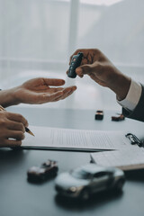 Car salesman gave the keys to the customers who signed the purchase contract legally, Successful...