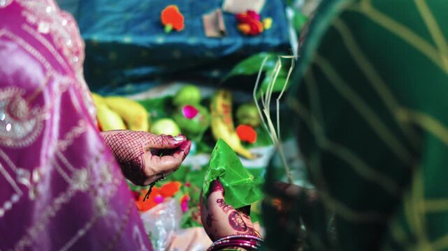 Women Performing Teej Pooja with Betel Leaves and Offerings