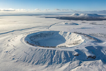 Aerial View of a Perfect Circular Crater in a Snowy Tundra
