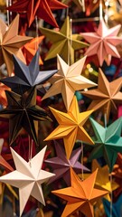 A cluster of vibrant, multicolored paper stars, likely origami, hang from strings, creating a festive and decorative display.