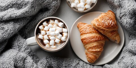 Cozy breakfast scene with coffee, marshmallows, and croissants