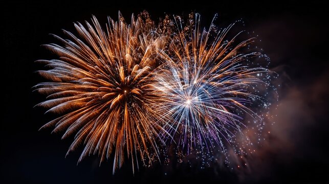 Vibrant bursts of orange, gold, and violet fireworks illuminate a dark night sky.