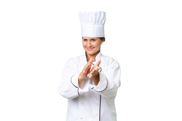 Middle-aged chef woman over isolated background applauding after presentation in a conference