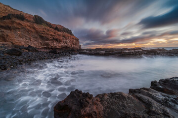 Coastal Inlet at Sunset with Long Exposure Water