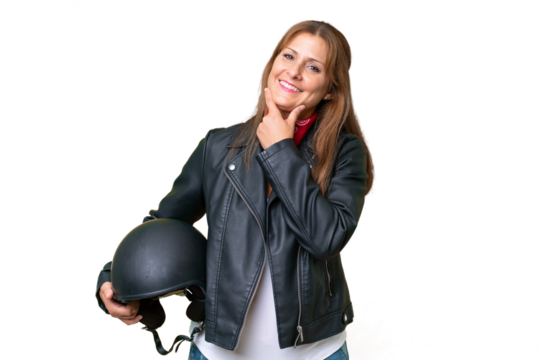 Middle-aged caucasian woman with a motorcycle helmet over isolated background happy and smiling - Powered by Adobe