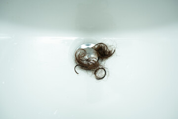 Top view hair loss problem in white sink.