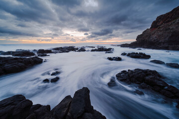 Coastal Inlet at Sunset with Long Exposure Water