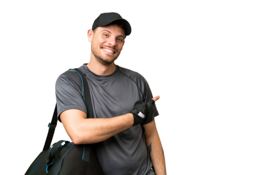 Young sport man with sport bag over isolated chroma key background pointing back - Powered by Adobe