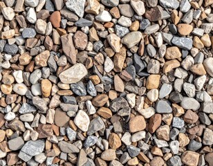 A close-up view of various colorful pebbles and stones arranged in a natural pattern on the ground.