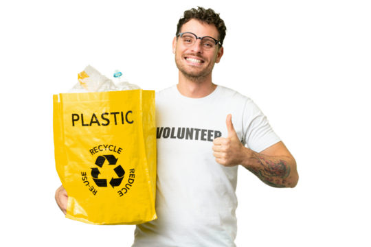Brazilian man holding a bag full of plastic bottles to recycle over isolated chroma key background with thumbs up because something good has happened